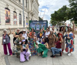Diversas ativistas posam com o carro de som, que está decorado com lenços verdes e cartazes da ação "Carro do Óvulo".